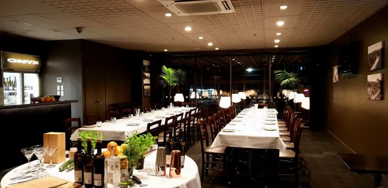 Elegantly set dining tables and bar inside Onyx bistro in Cambridge.