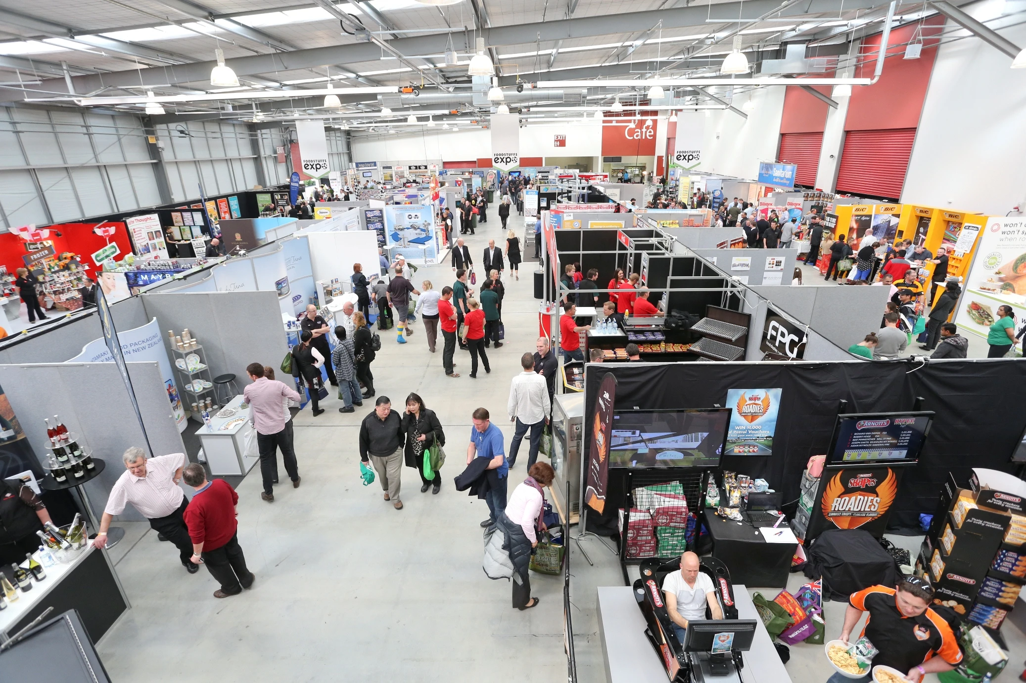 Visitors exploring exhibition stands inside Claudelands Event Centre in Hamilton.