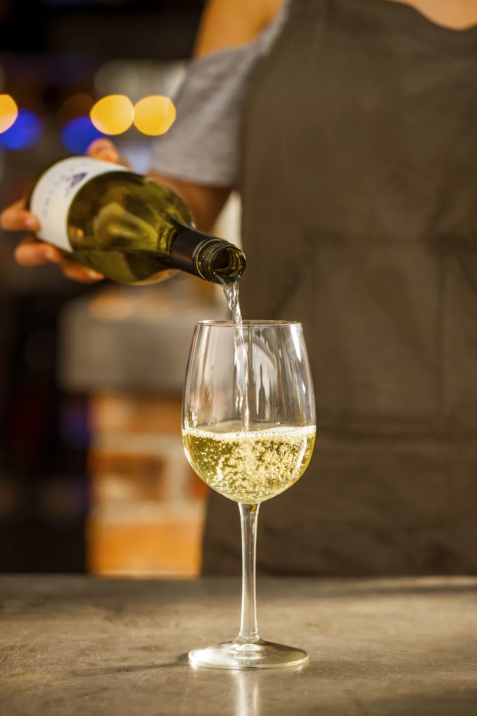 White wine being poured to accompany a meal.