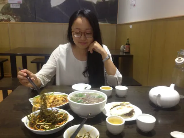 Annie enjoying a fresh bowl of Chinese noodles at a Hamilton East cafe.