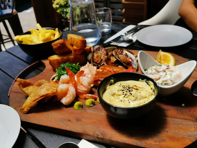 Generous fresh seafood platter with lemon and herbs served at Camarosa.