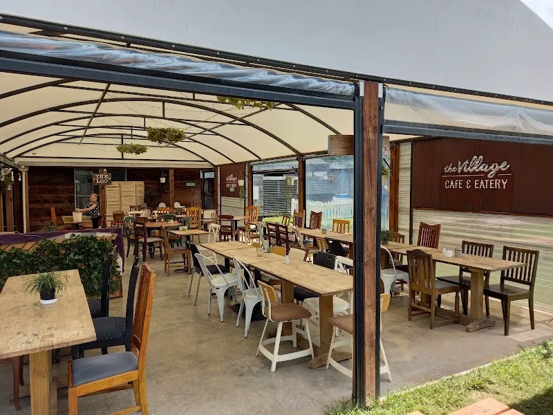 The Village Cafe & Eatery sheltered courtyard with dining tables in Raglan town.