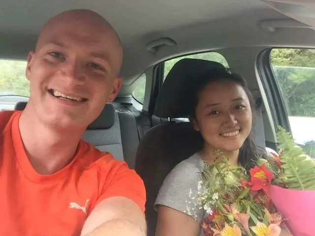 Isaac and Annie on a Waikato road trip with fresh flowers in the car.